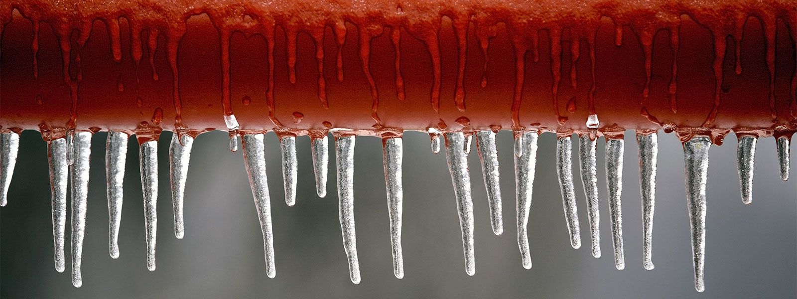 close up image of icicles on a pipe