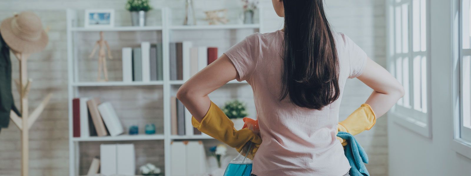 Woman with cleaning gear in her home