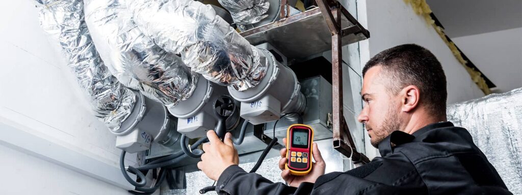 Technician monitoring air quality in ductwork