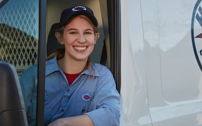 Female Haller tech leaning out van window