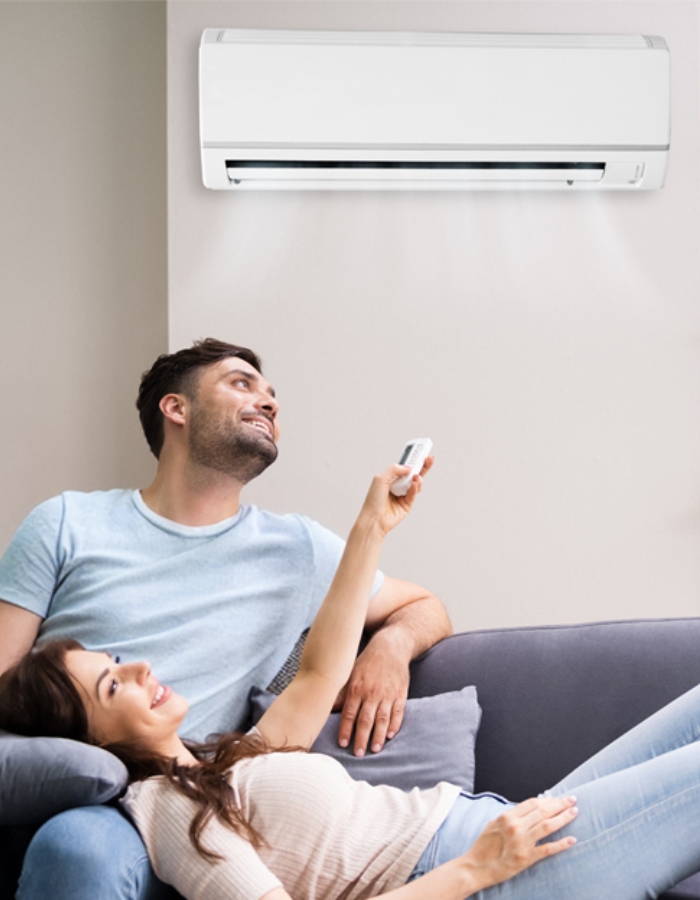 Homeowners relaxing under ductless mini split air conditioner