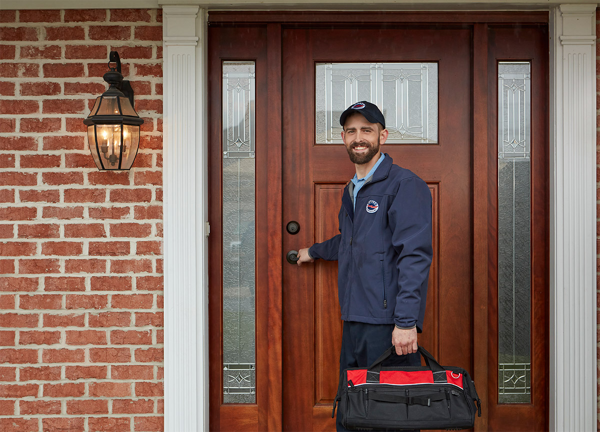Home service technician arriving at front door