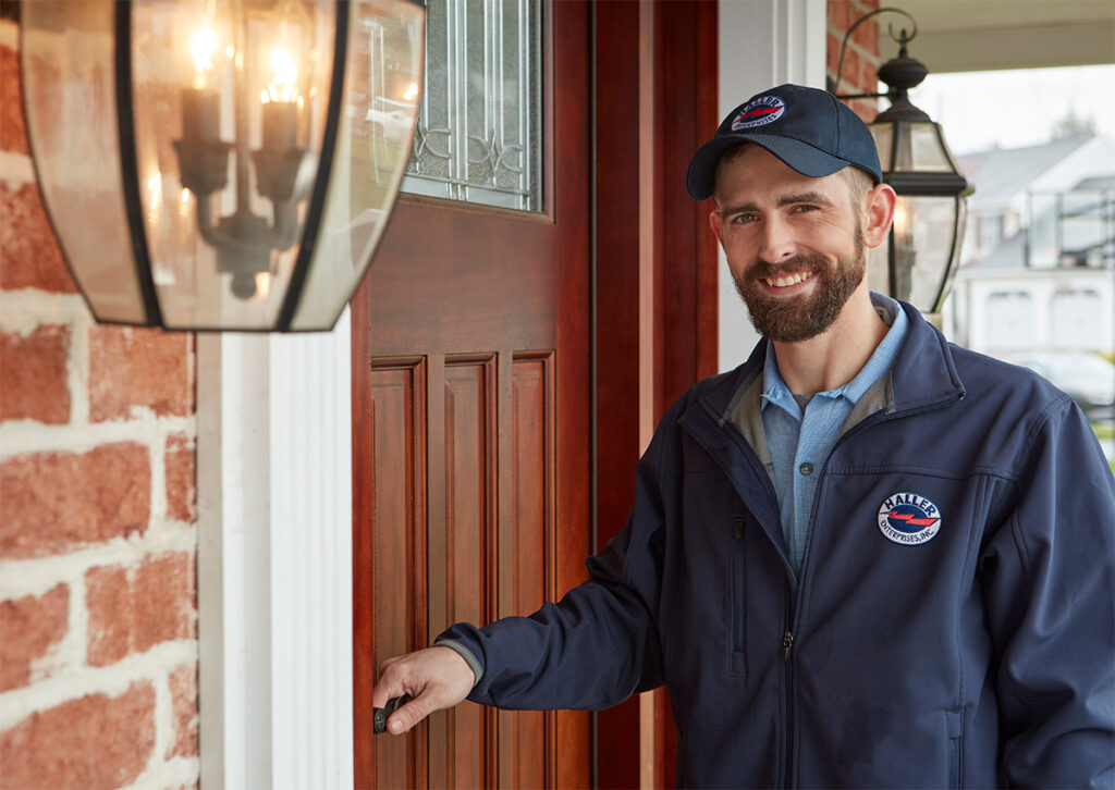 Friendly Haller Enterprises technician greeting homeowner