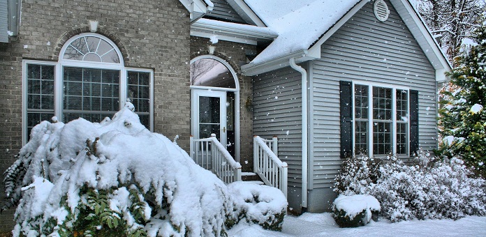 home in the winter with snow falling