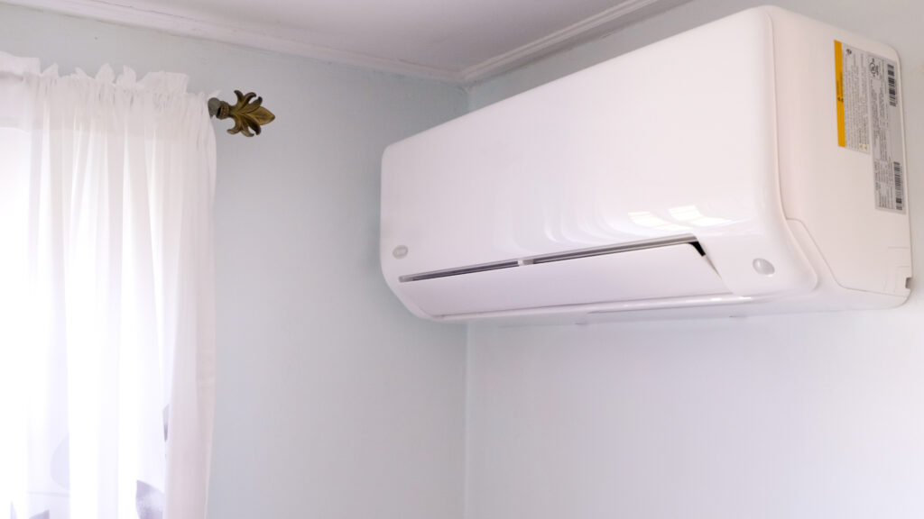 Heat pump mounted on an interior wall of a home