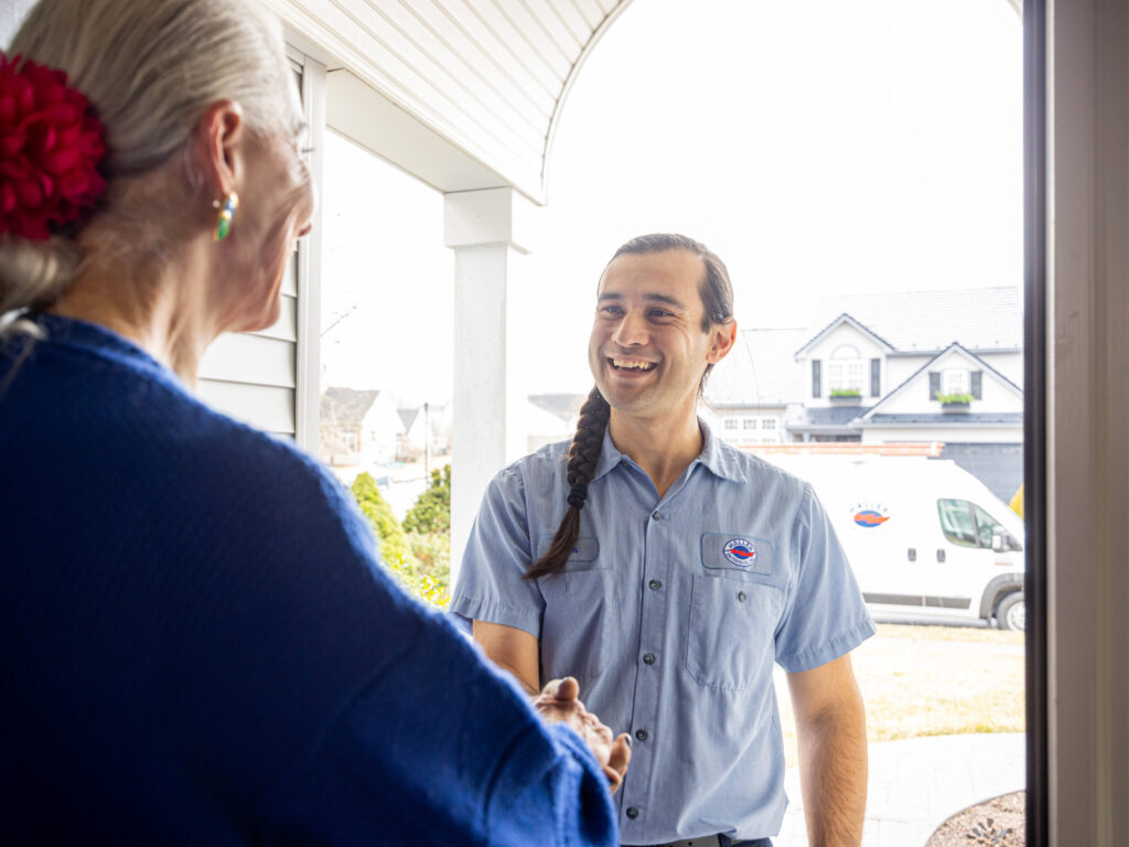 Homeowner greeting Haller technician at the door