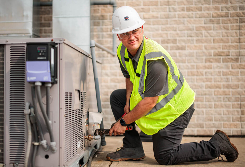 A HALLER commercial technician repair an outdoor commercial HVAC unit.