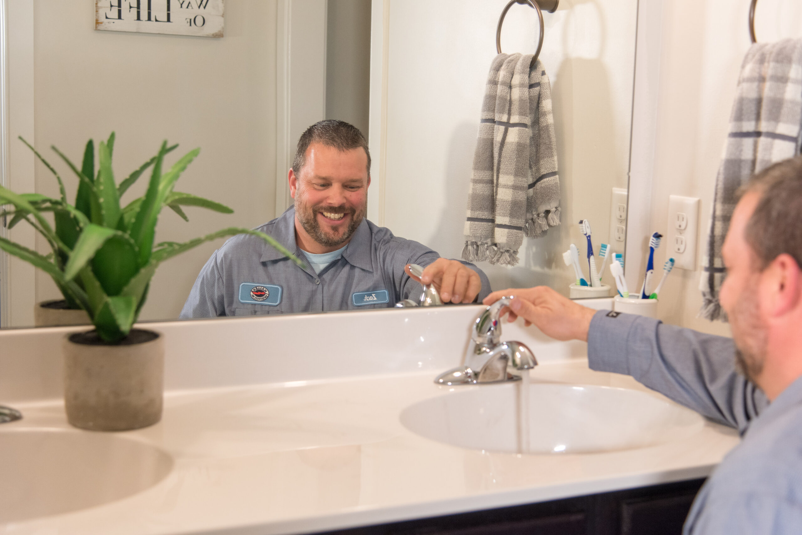 Haller Enterprises technician installing bathroom faucet