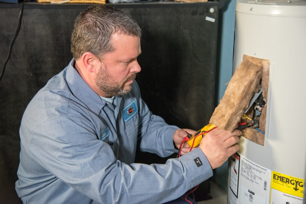 Technician installing plumbing components in residential home