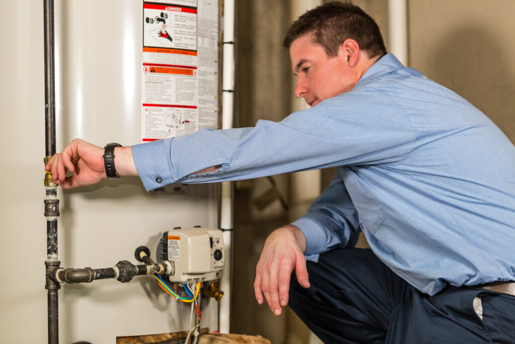 Haller enterprises technician looking at a water heater