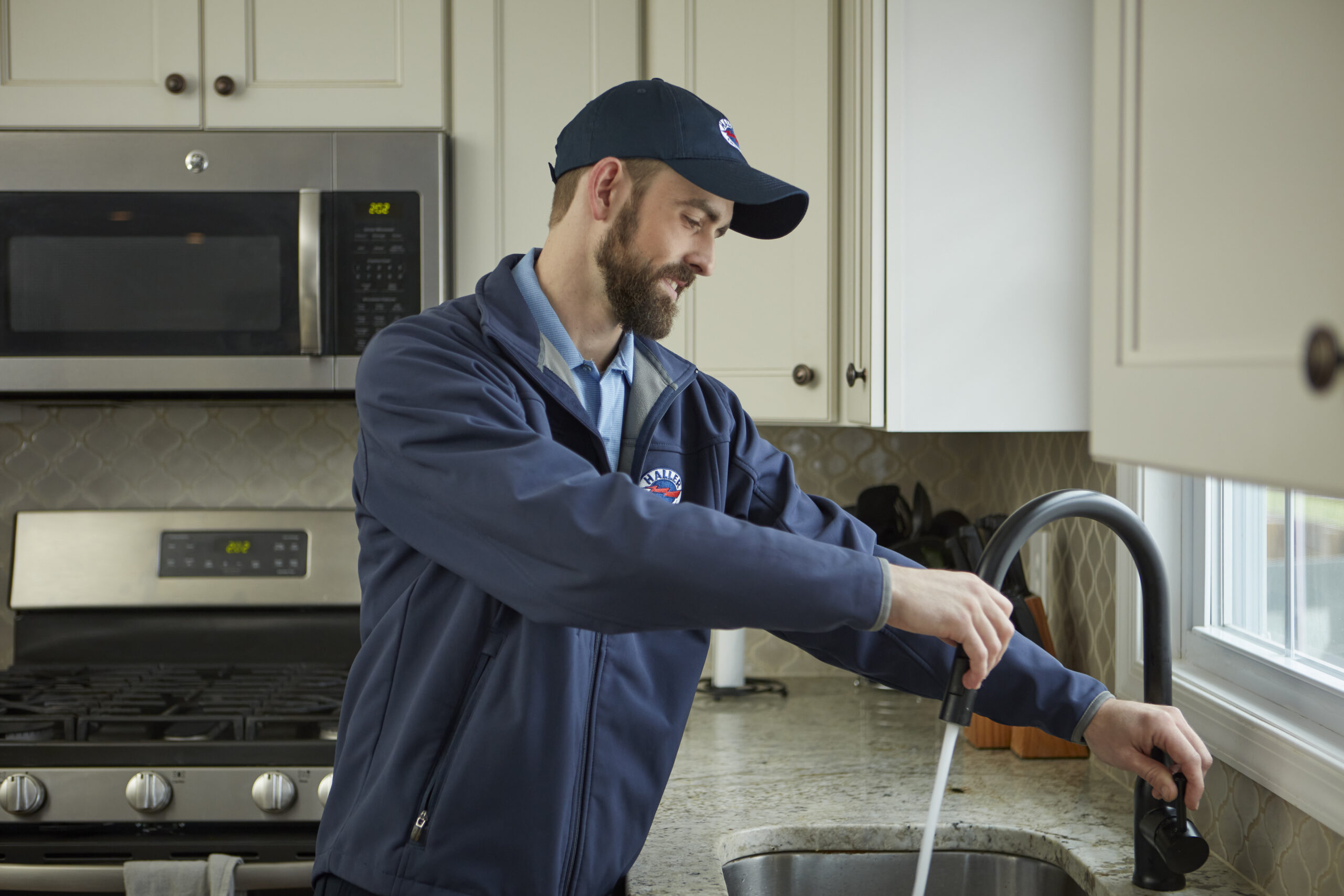 Haller Enterprises technician looking at a sink