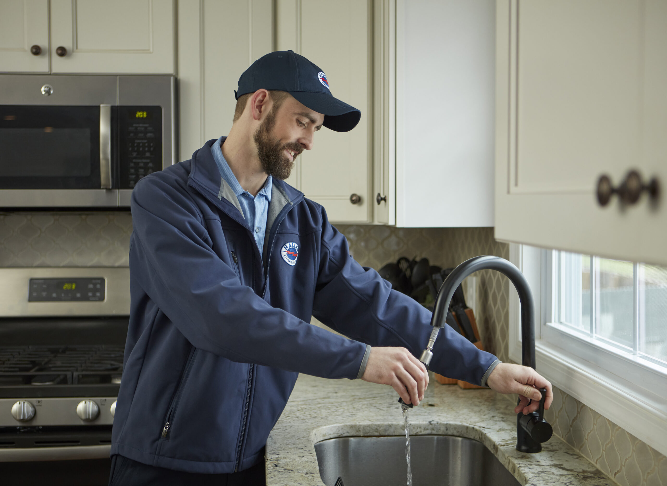 Licensed plumber repairing kitchen faucet in Pennsylvania home