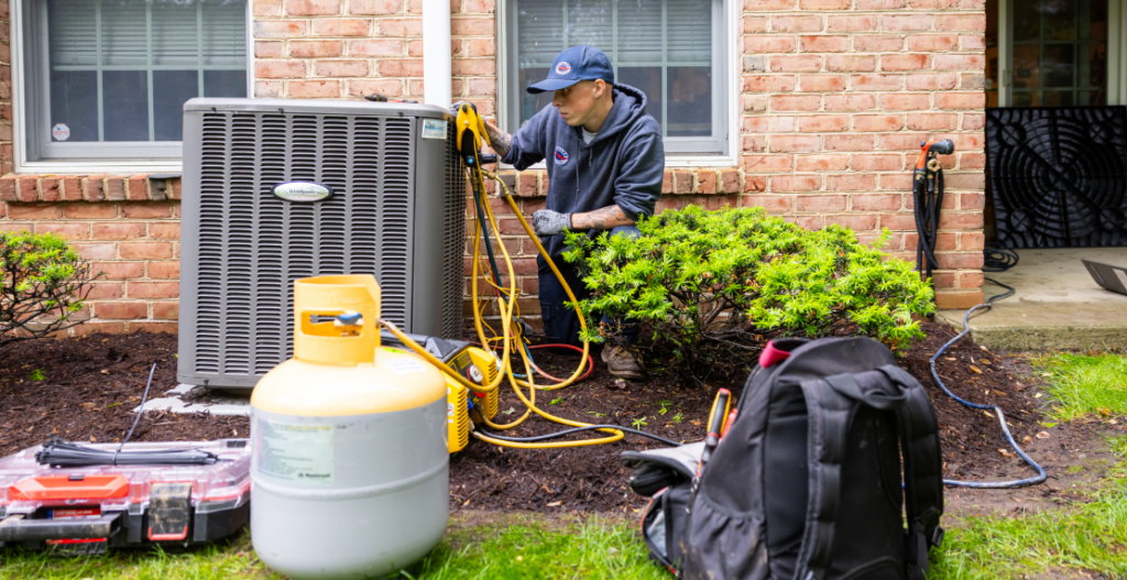 A Haller tech performs emergency ac repair on a home's outdoor unit in PA