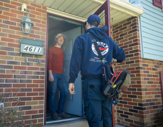 haller tech greeting a homeowner at the door