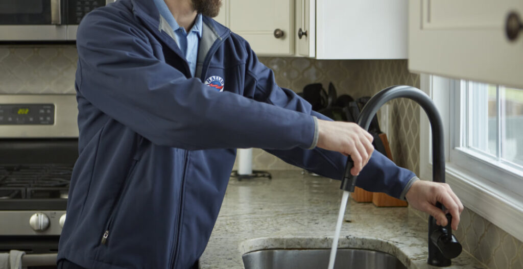 Plumbing turning on kitchen faucet