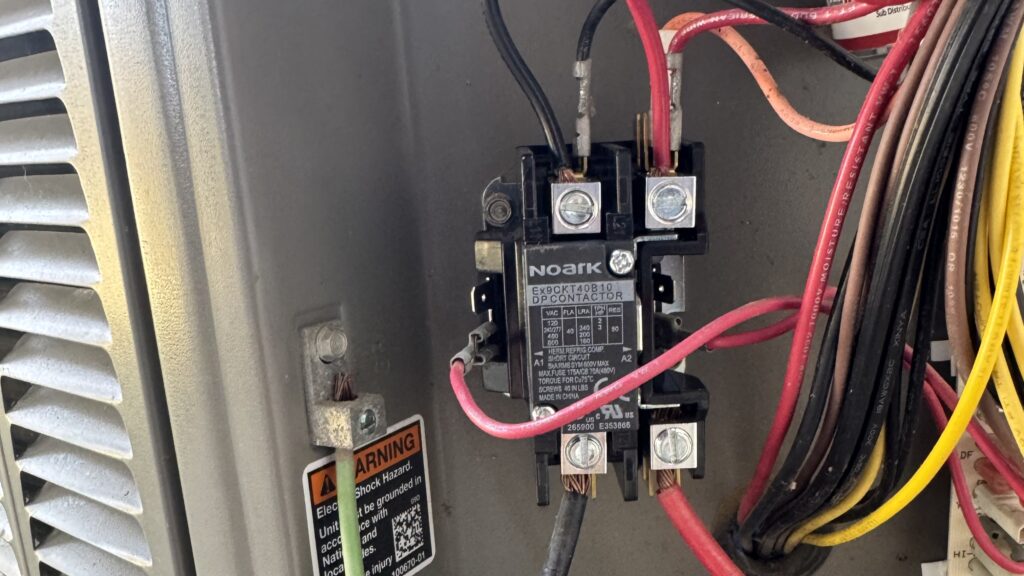 Close view of an AC contactor. A faulty contactor could be why your ac keeps shutting off