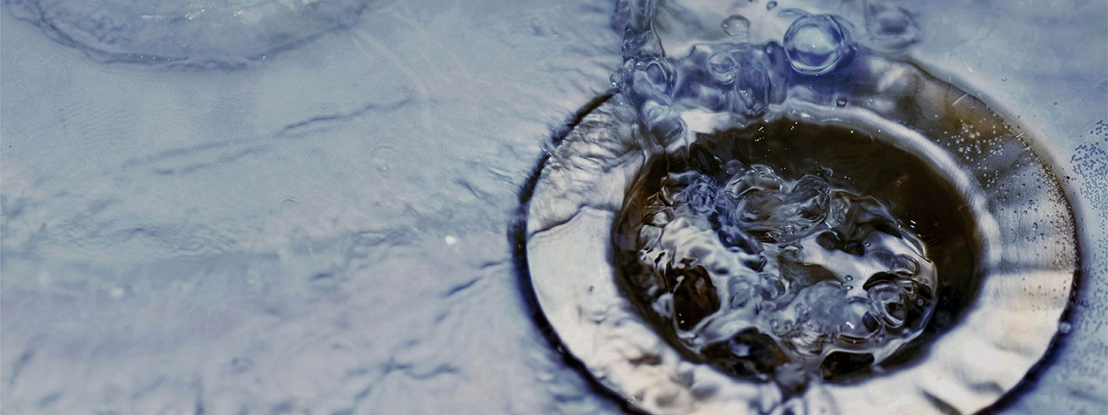 Close up of water going down a drain