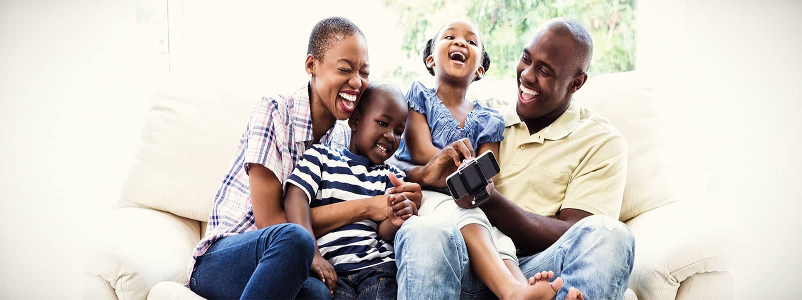 family on a couch laughing