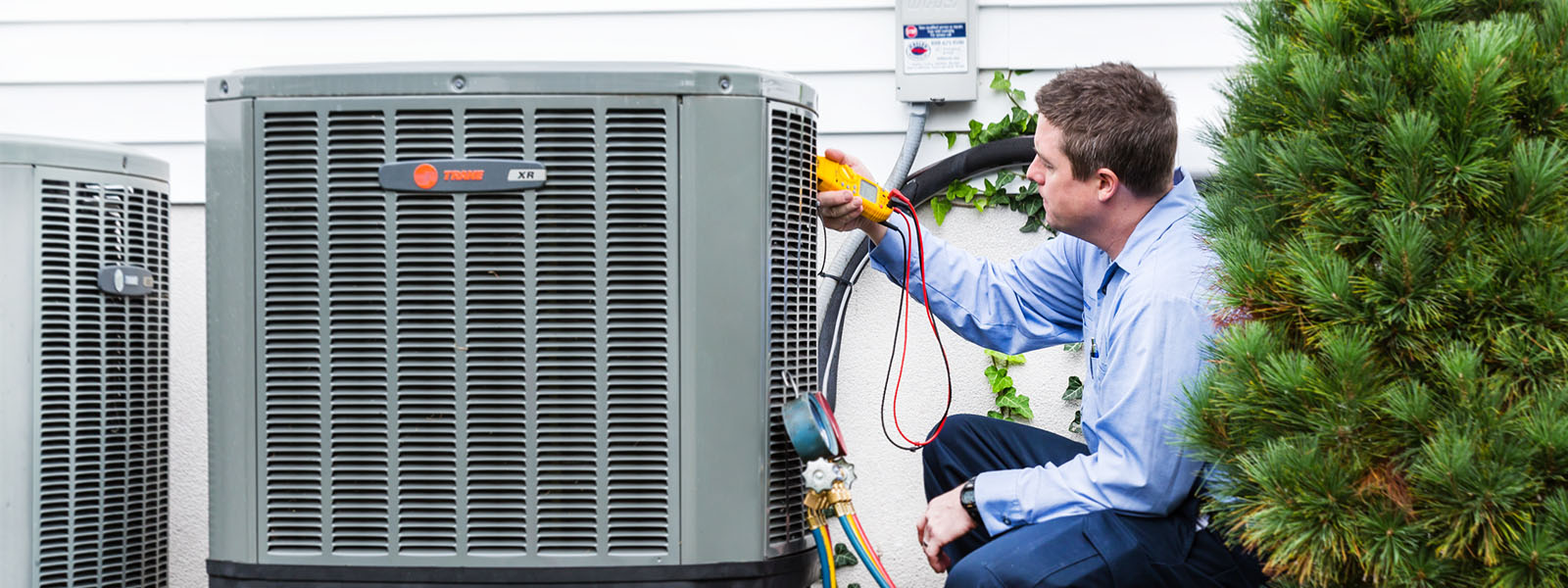 Haller technician working on heating system outside