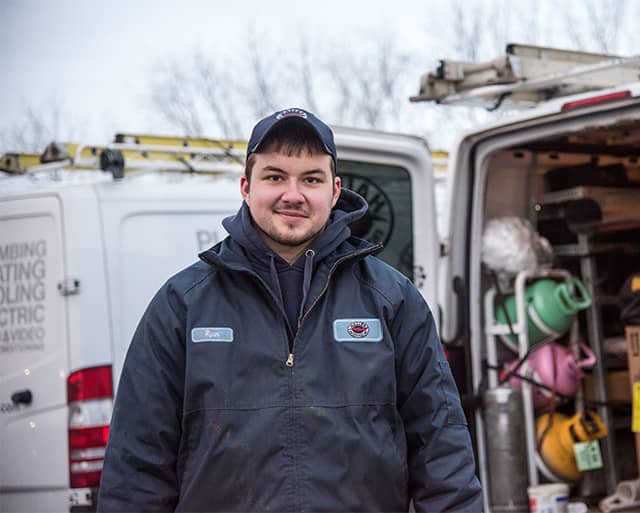 Haller Technician standing in front of truck