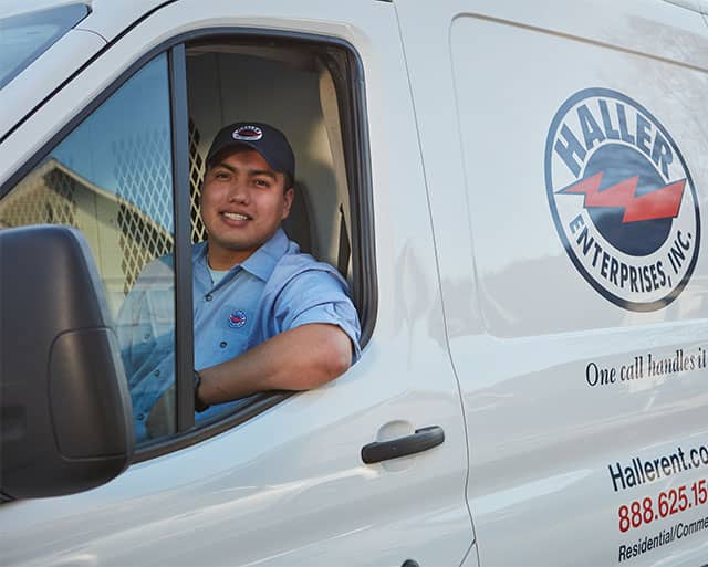 Haller technician smiling in drivers seat of van