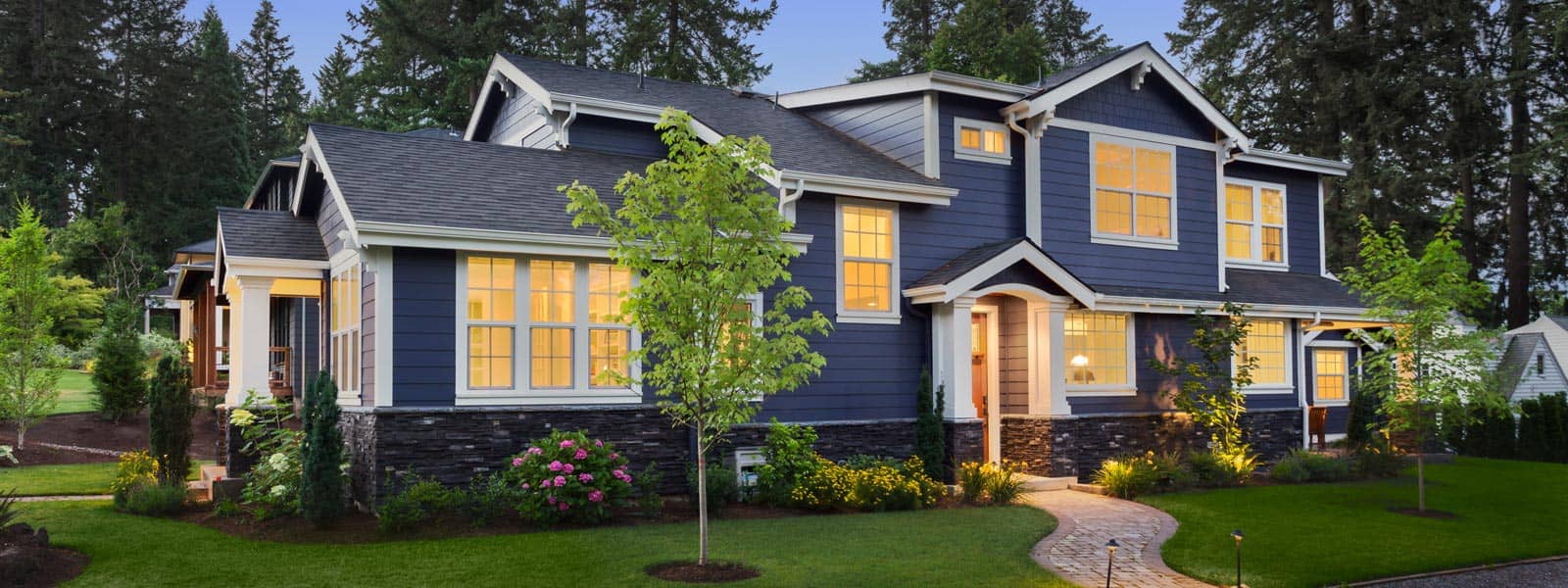 Beautiful blue home exterior with lights on