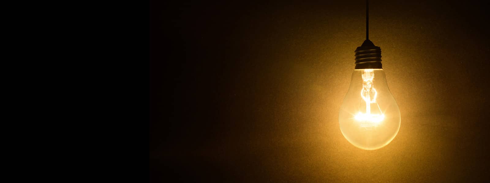 light bulb hanging in a dark scene