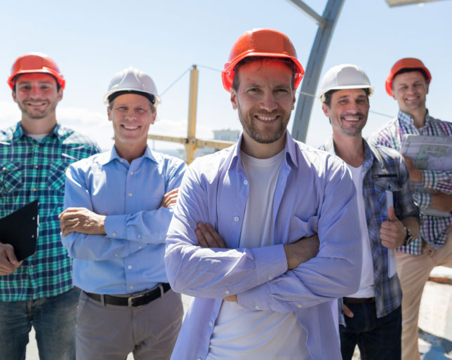 construction workers at a worksite with hard hats