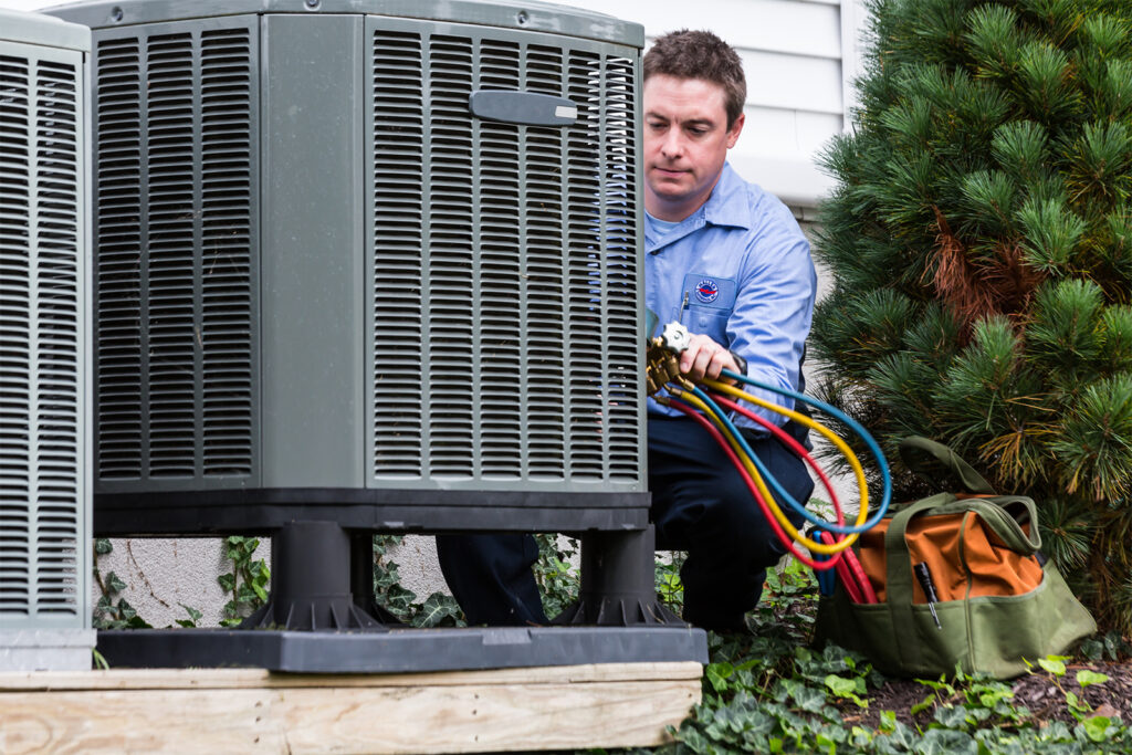 Haller tech servicing outdoor cooling unit heat pump.